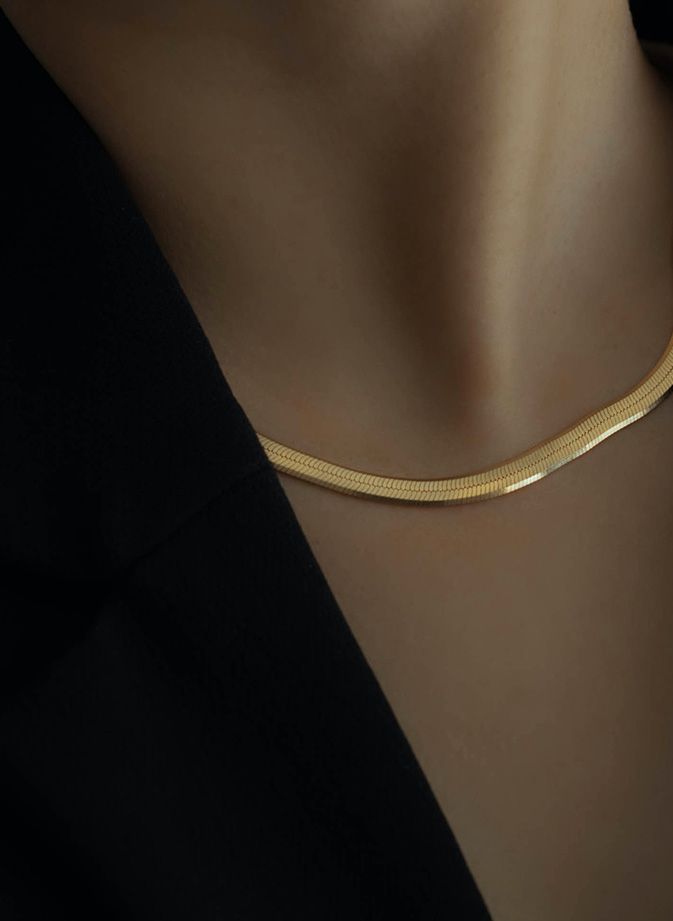 Close up crop of gold necklace