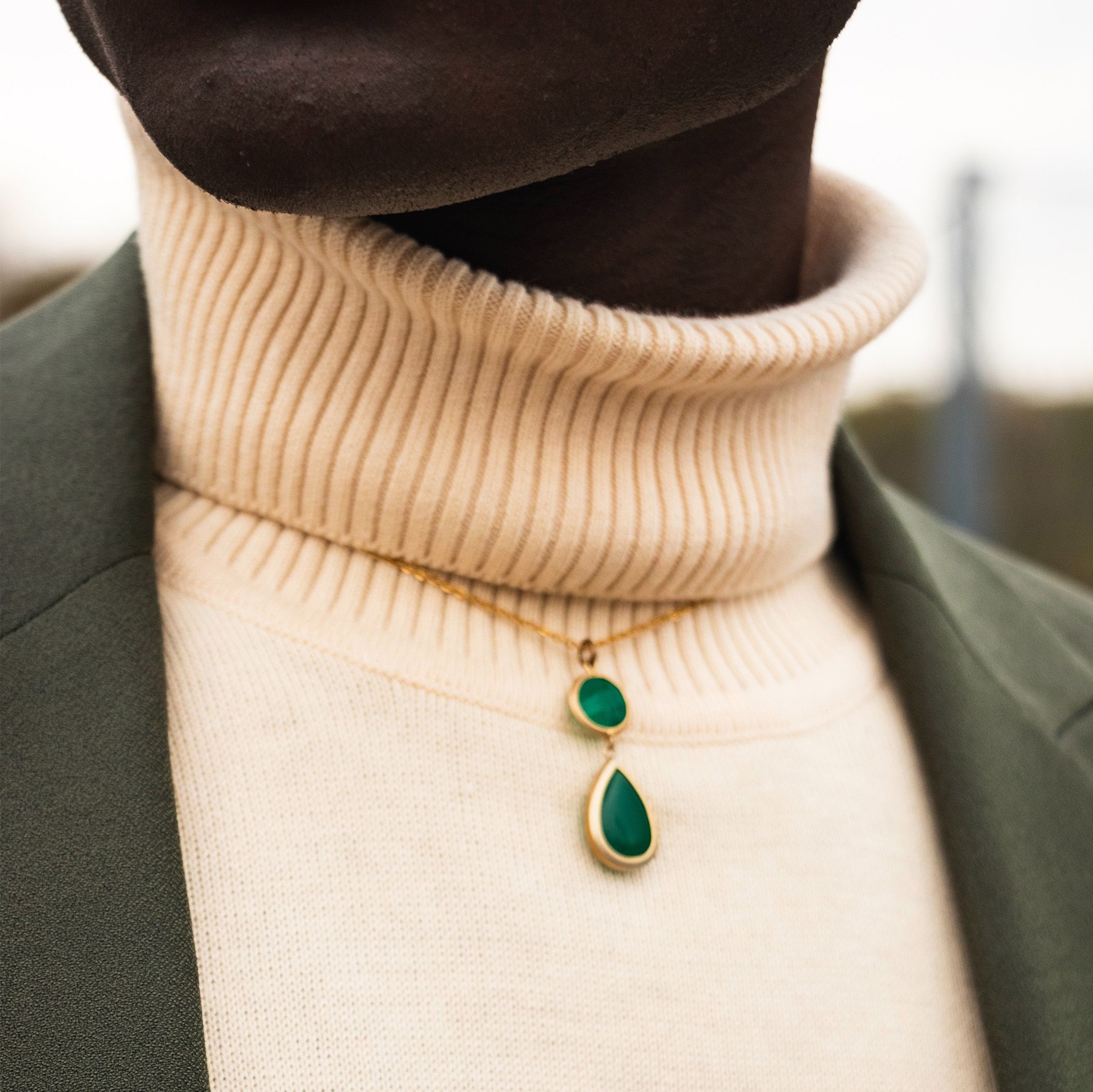 Black model with pearl necklace
